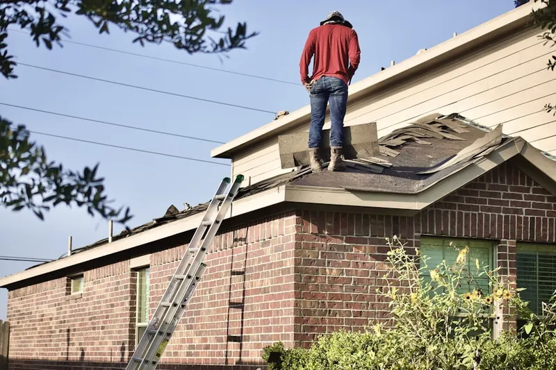 Professional roofer working on a residential roof in Blossom Meadows